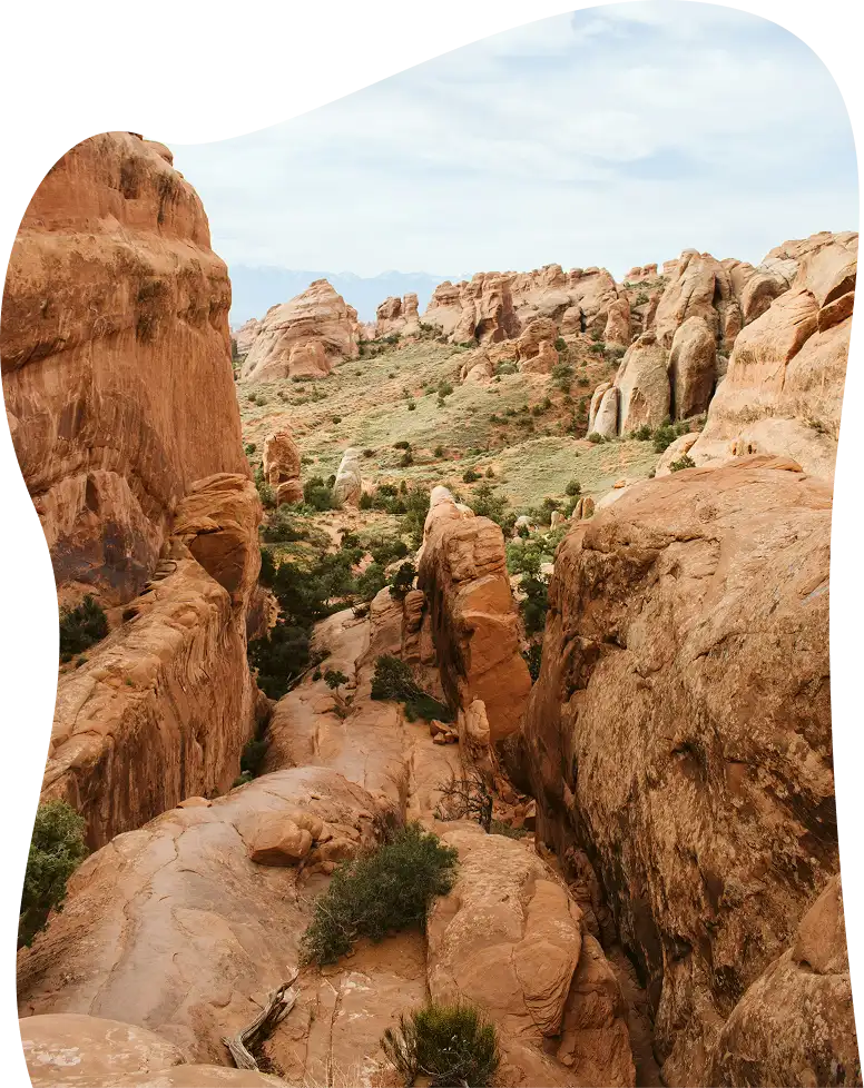 A desert landscape with large, weathered rock formations.